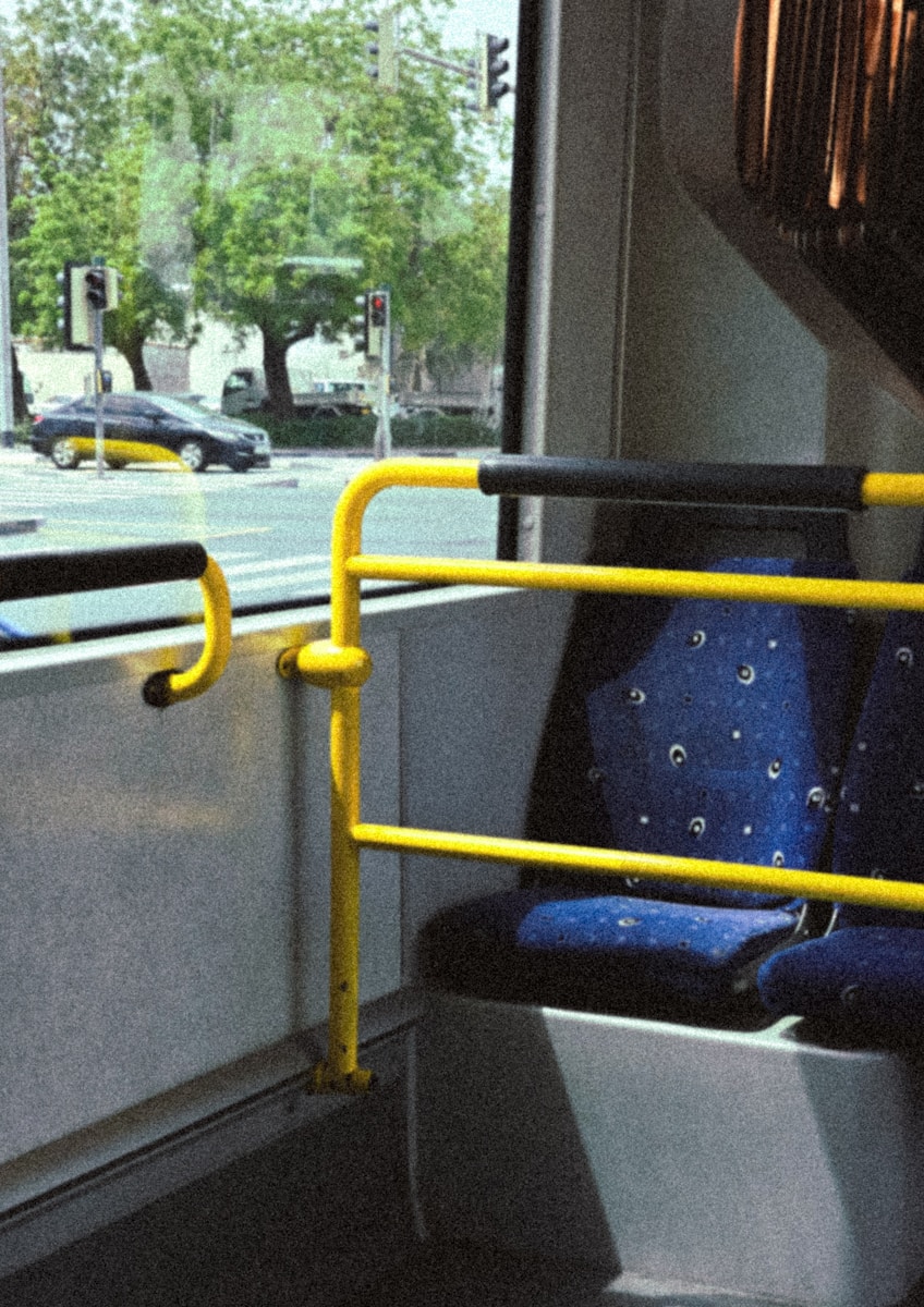 Inside of a bus with a view of the outside.